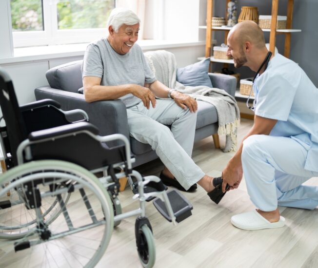 Äldre man får hjälp av en sjuksköterska i hemmet